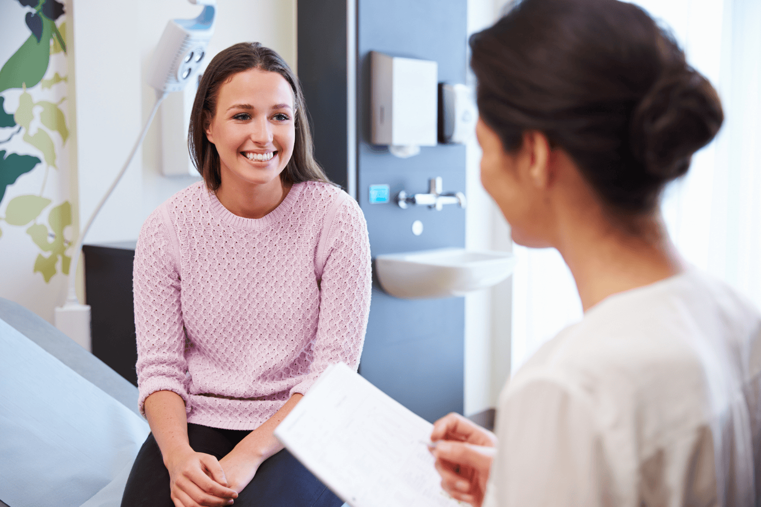 Patient and healthcare provider having a consultation in a medical office.